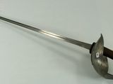 a sword with a wooden handle on a white surface