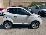 a white car parked in a parking lot next to other cars