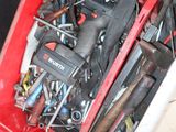 a red tool box filled with tools on a tiled floor