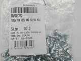 a close up of a bag of screws and nuts on a table