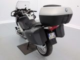 a black and silver motorcycle parked in a white room