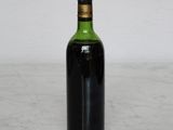 a bottle of wine sitting on a marble table