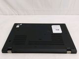 a black laptop sitting on top of a white sheet