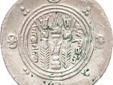 an old silver coin with a picture of a man on it