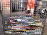 a metal cart with many books on it in a warehouse