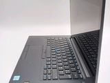 a laptop that is open on a white surface