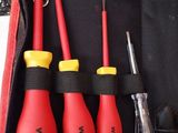 four tools in a red bag with a black handle