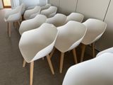 many white chairs lined up in a row in a room