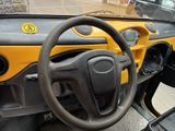 a steering wheel and dashboard of a small vehicle