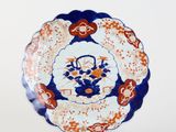 a close up of a plate with a flower design on it