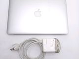 a laptop and a charger sitting on a table