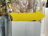 a yellow arrow pointing to the left of a box of flowers