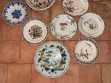 a lot of plates that are sitting on the floor