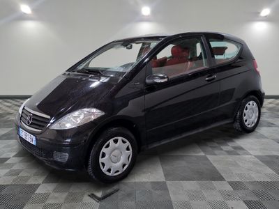 a picture of a small black car parked in a garage