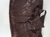 brown leather jacket and pants laying on a white surface
