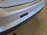 a close up of a car ' s bumper with a sticker on it