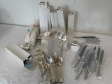 a lot of silver spoons and forks on the table