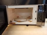 a microwave that has a glass bowl inside of it