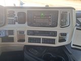a picture of a dashboard of a truck with a cell phone in it