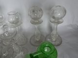 bottles and glasses are lined up on a white surface