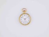 an antique pocket watch on a white surface with a white background