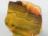 a picture of a piece of yellow and green marble on a metal stand