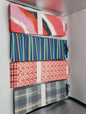 a wall that has a bunch of different pieces of art on it