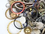 a pile of assorted bracelets and rings on a table