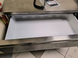 a coffee table with an open drawer underneath it