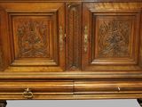 a large wooden cabinet with carvings on the doors