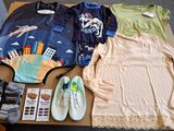 a table with a lot of clothing and shoes on it