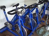 many bikes that are sitting on the floor in the room