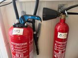 two fire extinguisors next to each other on the floor