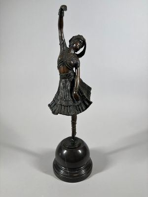 a bronze statue of a woman holding a ballerina on a black base