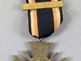 an image of a medal with a cross on it on a table