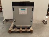 a small refrigerator sitting on a pallet in a warehouse