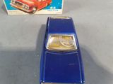a toy car that is sitting next to a box