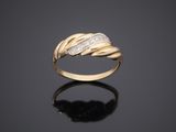 a yellow gold ring with diamonds on a black surface