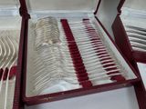 silverware in a red case on a table with a white table cloth