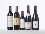several bottles of wine are lined up on a table