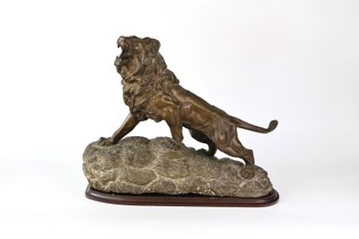 statue en bronze d'un lion sur un rocher sur fond blanc