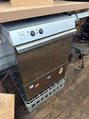 an image of a dishwasher sitting on top of a wooden table