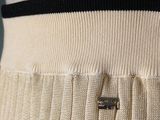 a close up of a white dress with a black stripe on the waist