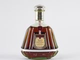 an image of a bottle of brandy sitting on a white surface