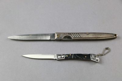 two knives that are laying next to each other on a table