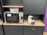 two microwaves and a microwave oven on a shelf