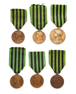a group of six medals and a medal on a white background