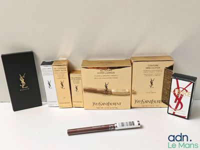 a lot of boxes of makeup and a pen on the table