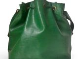 a green bucket bag sitting on top of a white surface