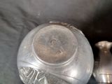 a silver vase and a silver vase on a black cloth